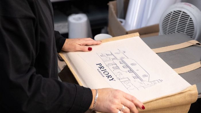 Tote bags being printed in the workshop